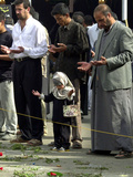 Iraqis, Inluding a Little Girl, Pause to Pray