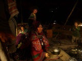 A Kuchi Woman Prepares Tea Where Her Family Sets Camp on the Outskirts of Kandahar