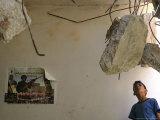 A Palestinian Boy Looks Inside the Damaged House of Militants Moatasm Sharaidi and Elias Ashkar