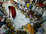 A Crowd of Women Who Pray in a Nearby Temple Six Hours a Day in Exchange for Meals and Money