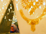 An Afghan Woman Looks for Gold at a Gold Shop