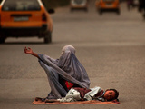 Buy A Girl, 7, Sick with Fever, Lies on a Street at AllPosters.com