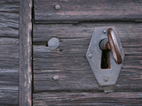 Close-up of an Old-Fashioned Skeleton Key in a Keyhole on an Old Wooden Door
