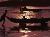 Man Pushing Dug-Out Canoe to Water's Edge with Two Children on Board, Esmeraldas, Ecuador