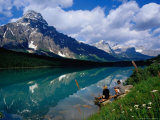 Buy Couple Sitting on Edge of Waterfowl Lake, Banff National Park, Canada at AllPosters.com