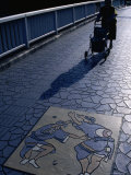 Buy Woman Walking Across Bridge Paved with Tessellated Tiles and Relief Art of Awa Odori Dancers, Japan at AllPosters.com