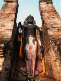Offerings at Feet of Buddha Statue, Sukhothai Historical Park, Thailand