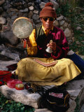 Buy Monk Performing Ritual in Chingdrol Chiling Park, Using Hand-Held Drum and Bell, Lhasa, China at AllPosters.com