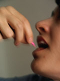 Woman Taking Pink Pill, Canada