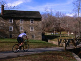 Buy Man Cycling Past Building in Rock Creek Park, Washington Dc, USA at AllPosters.com