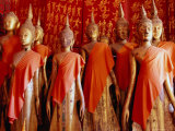 Buy Statues Draped in Saffron in the Royal Funerary Carriage House at Wat Xieng Thong, Laos at AllPosters.com