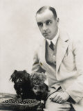 Man Sits with His Two Pekingese Dogs on a Cushion