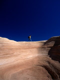 Crossing a Sandstone Cliff at Devil's Garden, Grand Staircase-Escalante National Monument, Utah