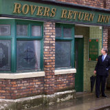 Buy Prince Charles Shelters from the Rain on the Set of "The Soap Coronation Street" at AllPosters.com