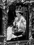 Queen Elizabeth II Riding Along in the Coronation Coach Wearing Crown and Carrying Orb