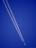 Buy Jumbo Jet Airliner Races Across a Clear Blue Sky with Vapor Trails at AllPosters.com