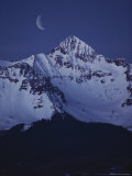 Buy Quarter Moon Sits Above the Snow-Capped Mountains at Night at AllPosters.com