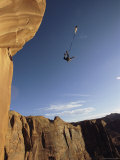 Buy Base Jumper Leaping with a Parachute From the Tombstone Formation at AllPosters.com