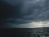 Crepuscular Rays of Sunlight Shine Behind a Passing Storm