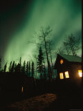 Buy Aurora Borealis Fills the Sky over a Warmly Lit Cabin at AllPosters.com