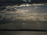 Crepuscular Rays of Sunlight Shine Through Clouds After a Storm