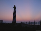 Cape Hatteras Lighthouse with Surrounding Sand Fence at Sunset