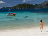 Woman Waiting for Boat on Beach