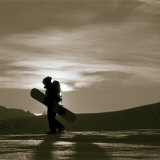 Silhouetted Snowboarder Hiking
