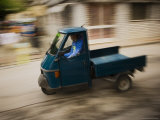 Buy Three Wheeled Vehicle known as an Ape Speeds By at AllPosters.com