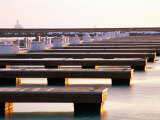 Buy Rows of Docks in Frozen Harbour with Lighthouse in Background at AllPosters.com