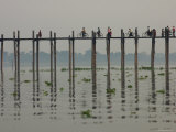 Buy People Ride their Bicycles Along U Bein's Bridge That Runs Down the Taungthaman Lake at AllPosters.com