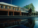 Buy Motorcyclist Riding Past Shops on Front Street at AllPosters.com