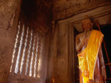Buy Lone Sculpture of Buddha Stands in a Cella at Angkor Wat at AllPosters.com