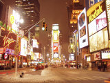 People and Cars in Snow-Filled Busy Street with Illuminating Signs in Times Square in New York City