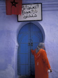 Woman Exits thru Moorish-Style Blue Door, Morocco