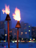 Lit Torches with Skyline in Background, Hawaii, USA