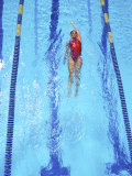 Young Woman Swimming Laps in a Pool