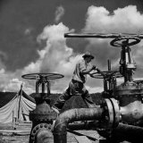 Worker Opening up a Pipeline to Let the Oil Flow