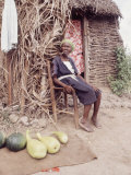 Old Haitian Woman in Front of Her Hut