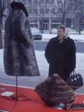 East German Woman Gawking at a Fur Coat in a Shop Window