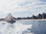 Haitian Beach Scene with a Fishing Boat Coming on Shore