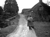 Tramp Named John Walpole Walking in Village Carrying Bag over His Shoulder