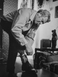 Policeman Eddie Egan Attaching Pistol to Ankle in Home