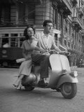 Man and Woman Riding a Vespa Scooter