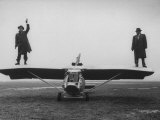 Buy Goodyear Aircraft Engineers Standing on Wings of Rubber Airplane, Can Fly 60 MPH with 200 yd Runway at AllPosters.com