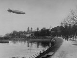 Buy The Hindenburg Airship of Zeppelin Design Flying over City Where it was Fabricated at AllPosters.com