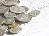 Pile of American Coins on Top of Stock Market Report