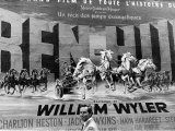 Actor Charlton Heston Posing in Front of Billboard of Film, Ben Hur