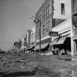 Buy Mud and Wreckage are Piled in Front of Stores Along Desolate Main Street on North Topeka at AllPosters.com