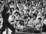Burlesque Female Impersonator Stripper Dee Light Dancing to a Large Audience of Men and Women
